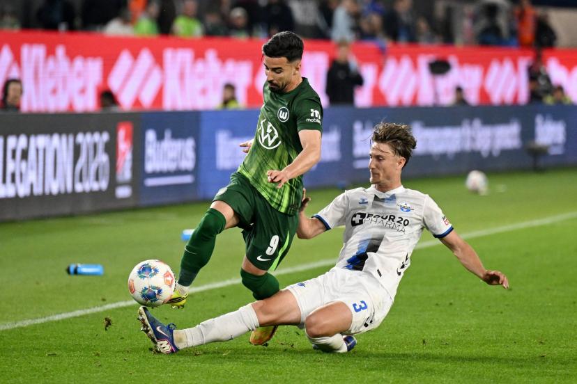 Wolfsburg's Mohammed Amoura battles Paderborn's Jonah Sticker during the Bundesliga relegation playoff first leg