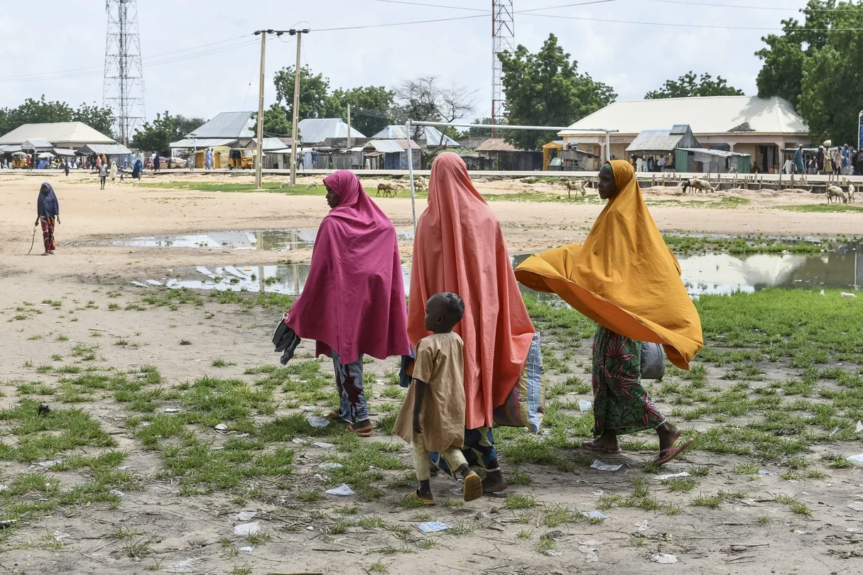 Survivors and relatives of victims of a suspected Boko Haram attack walk in Babban Gide on September 4, 2024. At least 81 people died and several are missing following an assault by presumed Boko Haram jihadists in Yobe State, northeastern Nigeria, local officials reported on September 3, 2024. 
