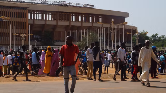 Local Nigeriens gather near Niamey’s General Seyni Kountché Stadium for a civilian militia recruitment drive on August 19, 2023.