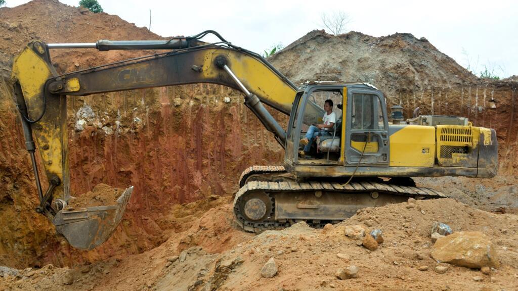 A Chinese employee operates an excavator at a mining site in Betare Oya, Cameroon, April 4, 2018.