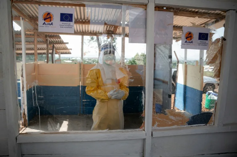 Health workers in protective gear attending to a patient during the Ebola outbreak in Democratic Republic of Congo